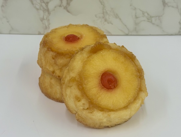 Cinotti's Individual Pineapple Upside-down cake: 4inch cake made with a signature brown sugar base, yellow cake, and pineapple ring with a Marchino cherry garnish. Packed 36 per case