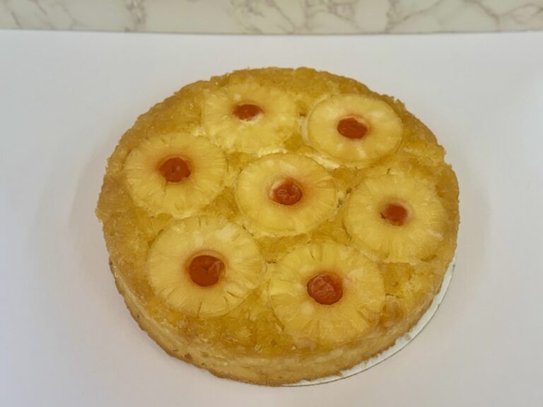 Cinotti's Individual Pineapple Upside-down cake: 10 inch cake made with a signature brown sugar base, yellow cake, and crushed and ring pineapples with a Maraschino cherry garnish. Packed 1 per case