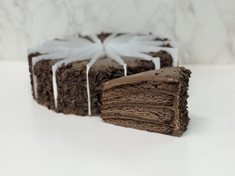 Cinotti's Sawgrass Cake: Wholesale 4 layers of decadent chocolate cake with rich, creamy chocolate icing and chocolate curls. 14 Slice